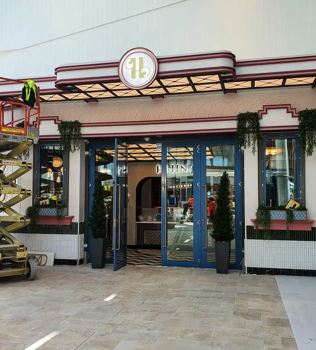 Exterior view of the entrance to an Archie Brothers premise, blue metal framed glass doors, retro styled building